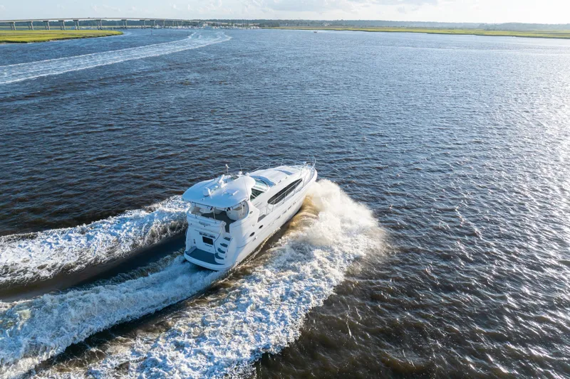  Yacht Photos Pics 2007 Sea Ray 40 Motor Yacht cruising on open water, leaving a wake behind.