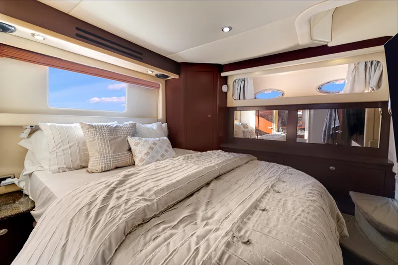  Yacht Photos Pics Luxurious bedroom interior of 2007 Sea Ray 40 Motor Yacht with elegant bedding and windows.