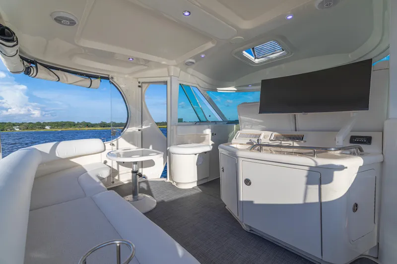  Yacht Photos Pics Luxurious 2007 Sea Ray 40 Motor Yacht interior with seating, table, and TV, overlooking water.