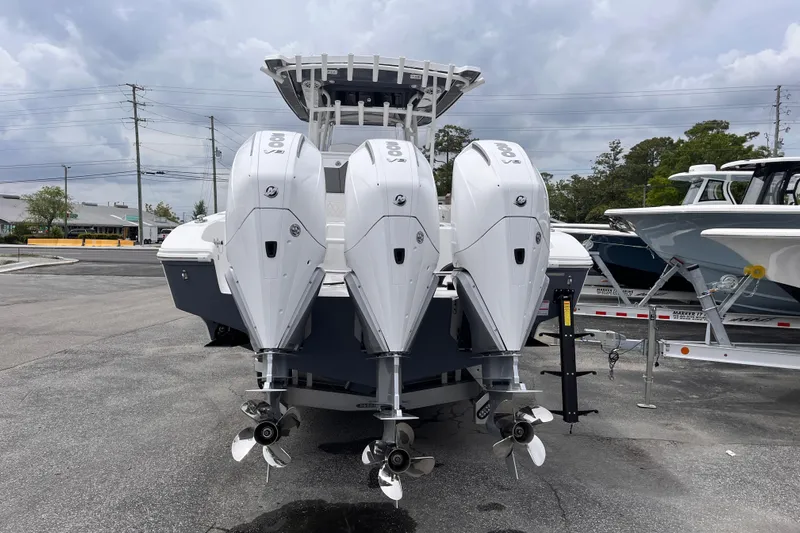  Yacht Photos Pics 2025 Fountain 34 Tournament Edition boat with triple outboard engines, parked on a trailer.