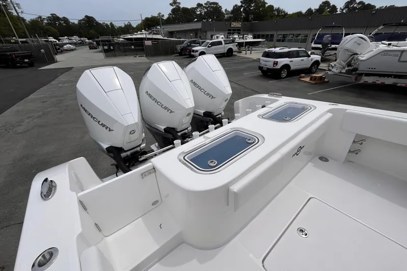  Yacht Photos Pics 2025 Fountain 34 Tournament Edition boat with triple Mercury outboard engines in a marina setting.