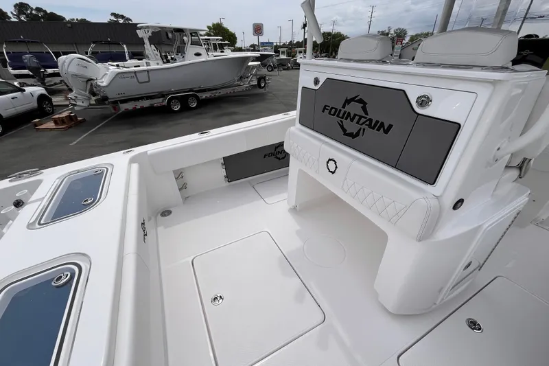  Yacht Photos Pics 2025 Fountain 34 Tournament Edition boat interior with seating and storage, parked in a dealership lot.