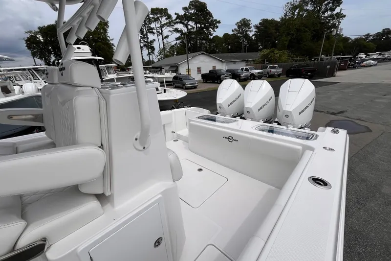  Yacht Photos Pics 2025 Fountain 34 Tournament Edition boat with triple Mercury engines, parked outdoors.