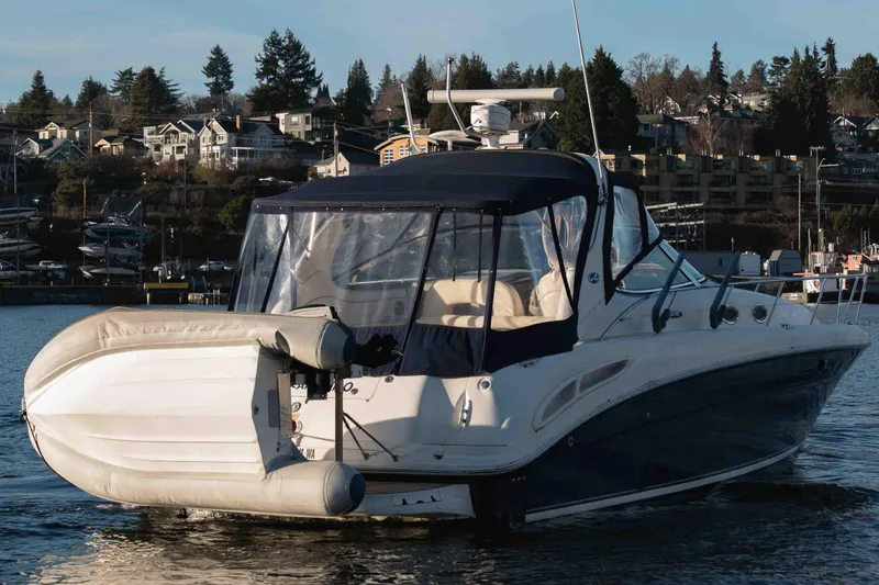  Yacht Photos Pics 2004 Sea Ray 360 Sundancer yacht with inflatable boat, docked near waterfront homes.