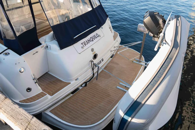  Yacht Photos Pics 2004 Sea Ray 360 Sundancer yacht with attached dinghy on calm water.