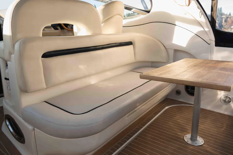 Yacht Photos Pics Interior of 2004 Sea Ray 360 Sundancer with beige seating and wooden table.