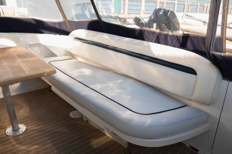  Yacht Photos Pics 2004 Sea Ray 360 Sundancer interior with white seating and wooden table.