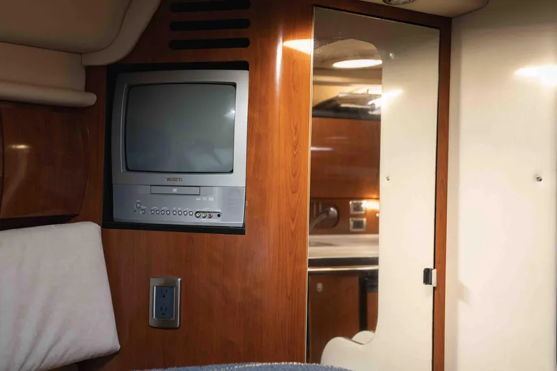  Yacht Photos Pics Interior of 2004 Sea Ray 360 Sundancer with built-in TV and wooden cabinetry.
