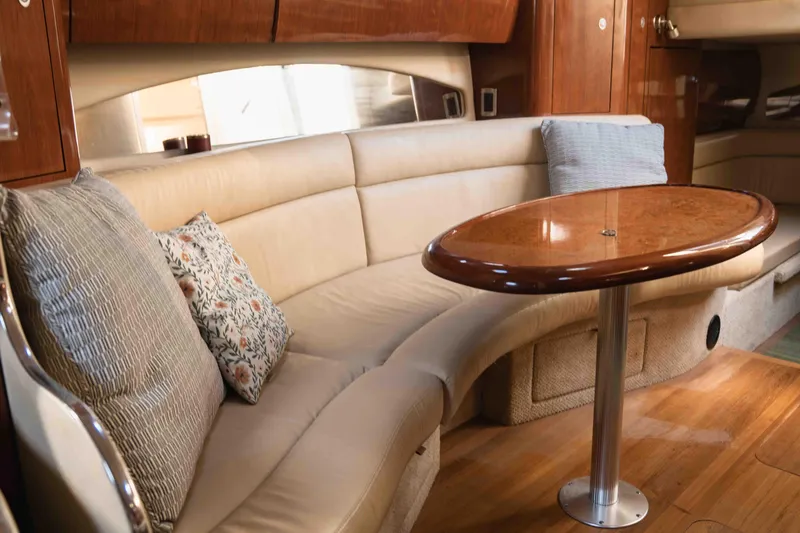  Yacht Photos Pics Luxurious interior of 2004 Sea Ray 360 Sundancer with plush seating and elegant wooden table.