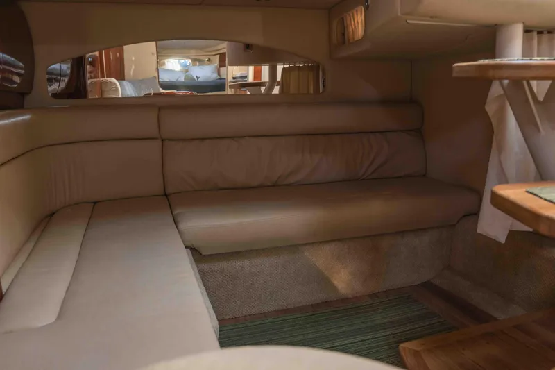  Yacht Photos Pics 2004 Sea Ray 360 Sundancer interior with beige seating and wooden accents.