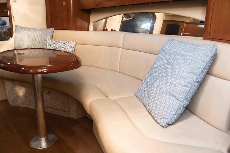  Yacht Photos Pics 2004 Sea Ray 360 Sundancer interior with beige seating and wooden table.