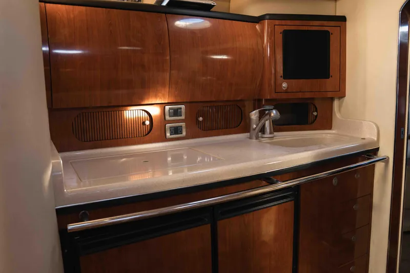  Yacht Photos Pics Luxurious 2004 Sea Ray 360 Sundancer yacht kitchen with wood cabinetry and modern fixtures.
