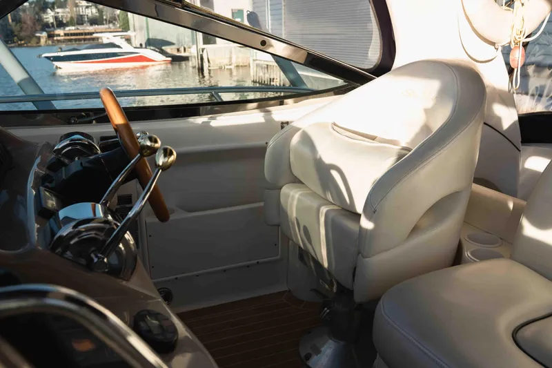  Yacht Photos Pics Interior of 2004 Sea Ray 360 Sundancer boat with helm and leather seating.