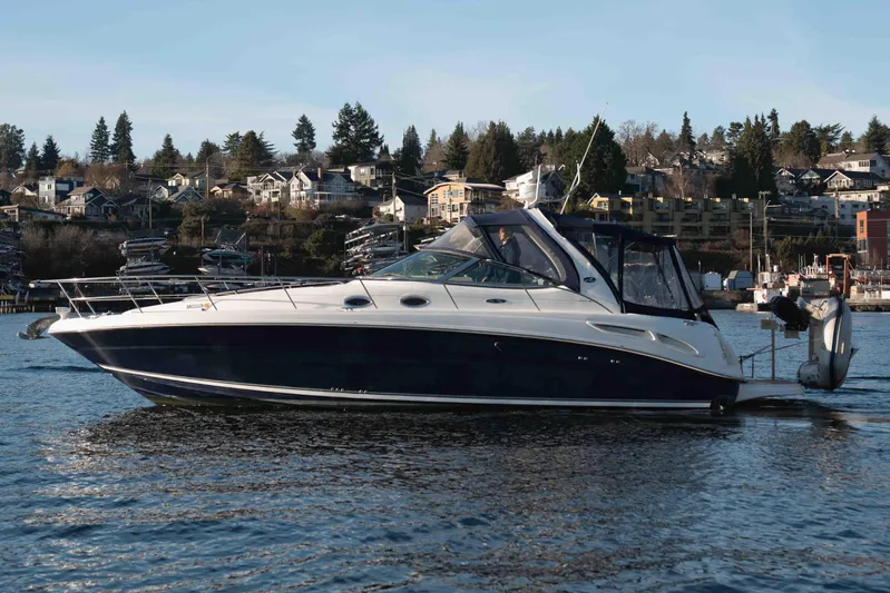  Yacht Photos Pics 2004 Sea Ray 360 Sundancer yacht on calm water with scenic shoreline background.