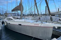 Sailboat Allures 45, 2012 model, docked in marina with clear blue sky.