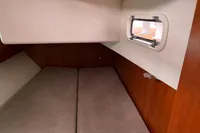 Allures 45 yacht cabin interior, 2012 model, featuring a cozy bed and small window.