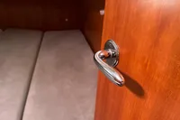 Chrome door handle on wooden door inside 2012 Allures 45 yacht cabin.