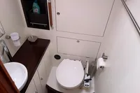 Compact bathroom in a 2012 Allures 45 yacht, featuring a toilet and sink.
