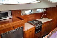 Luxurious Allures 45 yacht kitchen interior with wood finish, stove, and microwave, 2012 model.