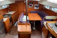 Luxurious 2012 Allures 45 yacht interior with wooden finishes and purple seating.