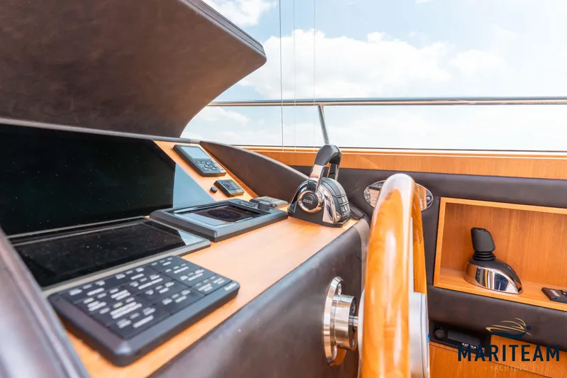 Onderonsie Yacht Photos Pics Wheelhouse interior of 2017 Breedendam MTB fourzero, featuring modern navigation equipment and wooden accents.