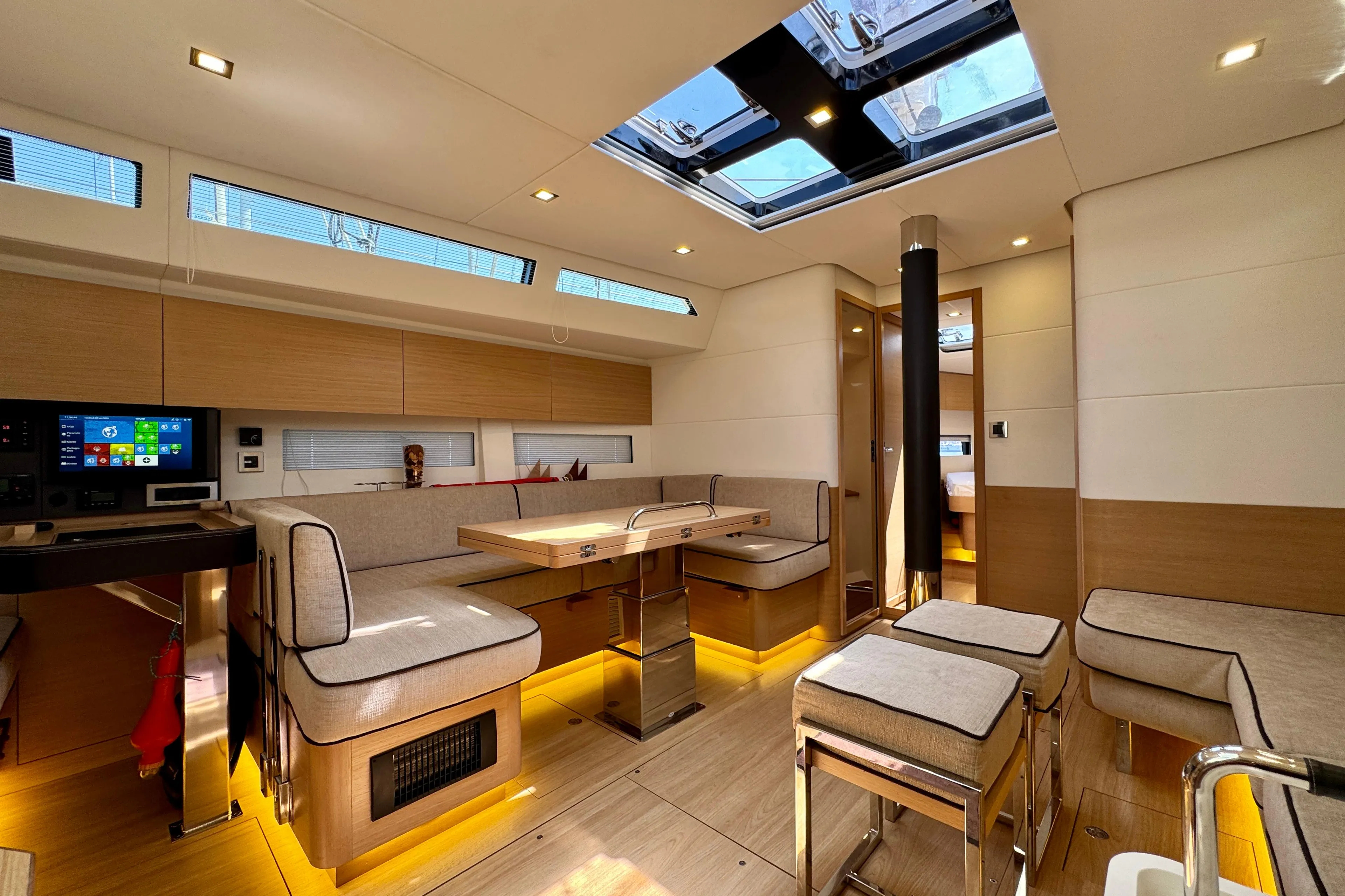 Luxurious interior of a 2017 Amel 50 yacht with modern furnishings and skylight.
