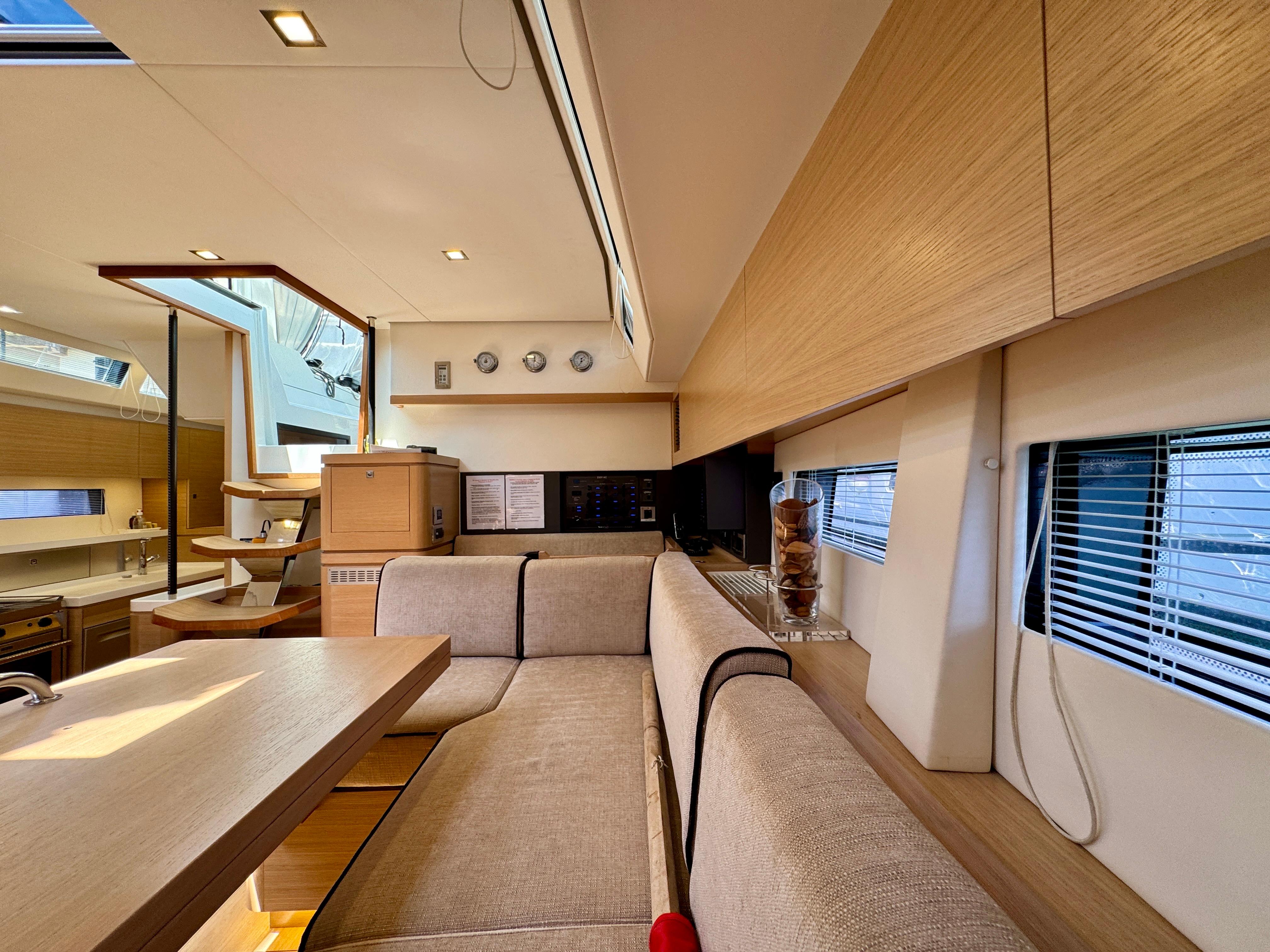 Luxurious interior of a 2017 Amel 50 yacht with modern furnishings and ample natural light.