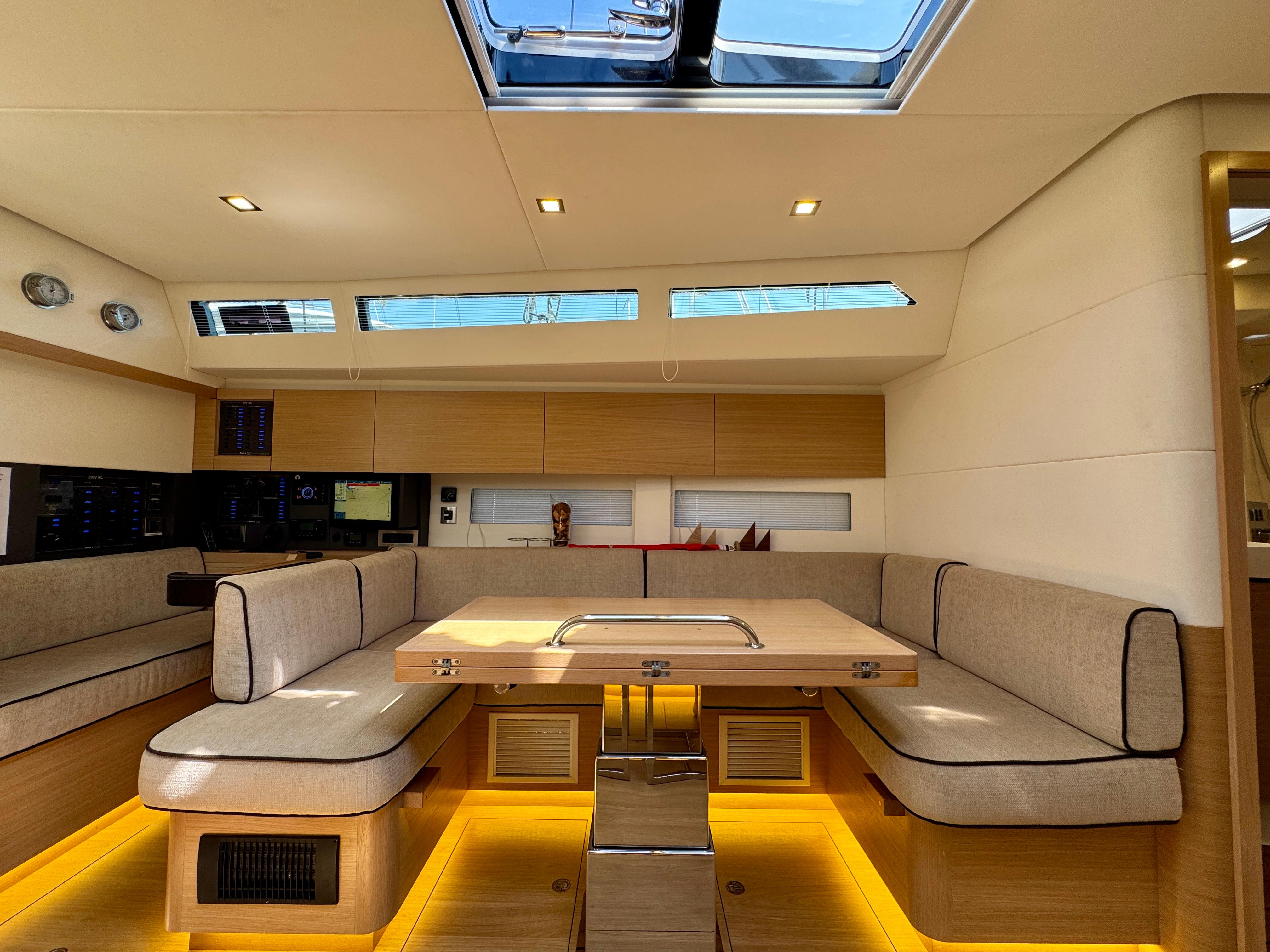 Luxurious interior of a 2017 Amel 50 yacht with modern seating and skylight.