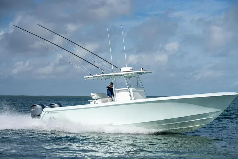  Yacht Photos Pics 2025 Contender 39 ST boat cruising on open water under a cloudy sky.