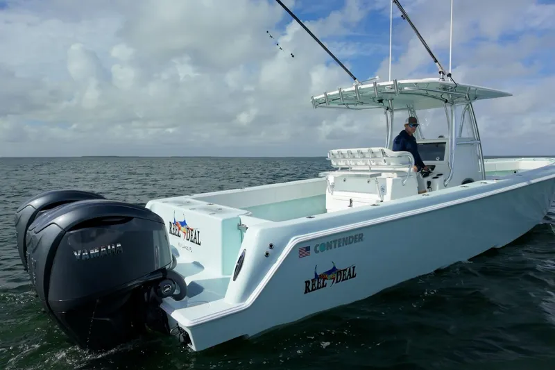  Yacht Photos Pics 2025 Contender 39 ST boat on water, featuring dual Yamaha engines, under cloudy sky.