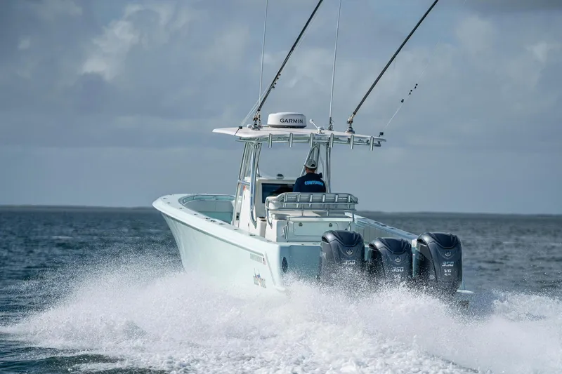  Yacht Photos Pics 2025 Contender 39 ST boat cruising on open water with triple engines.