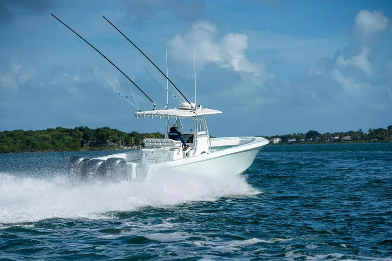  Yacht Photos Pics 2025 Contender 39 ST boat speeding on open water with fishing rods.