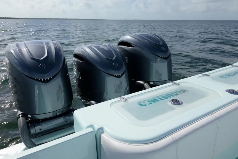  Yacht Photos Pics 2025 Contender 39 ST boat with triple outboard engines on open water.