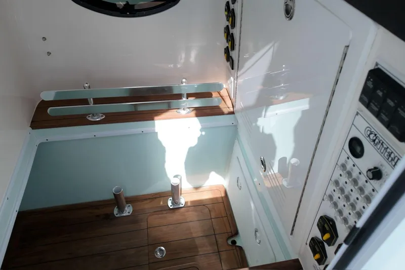  Yacht Photos Pics 2025 Contender 39 ST boat interior with wood flooring and control panel.
