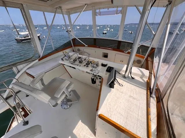 1985 Post 43 Convertible boat helm with ocean view and moored boats.