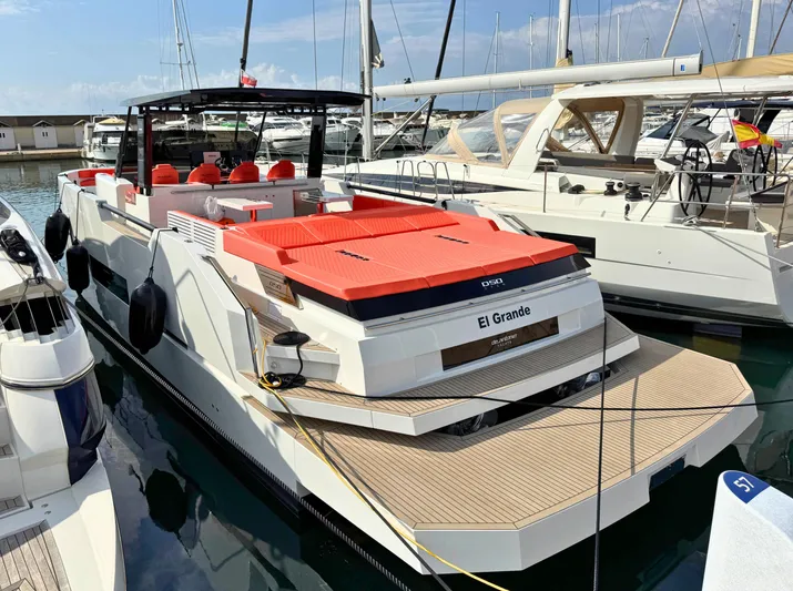  Yacht Photos Pics 2025 De Antonio Yachts D50 docked, featuring sleek design and vibrant red seating.