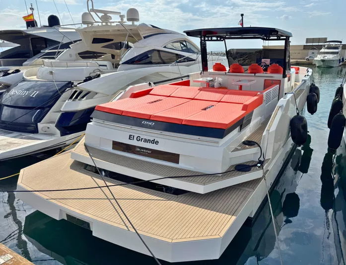  Yacht Photos Pics 2025 De Antonio Yachts D50 "El Grande" docked, featuring sleek design and vibrant red seating.