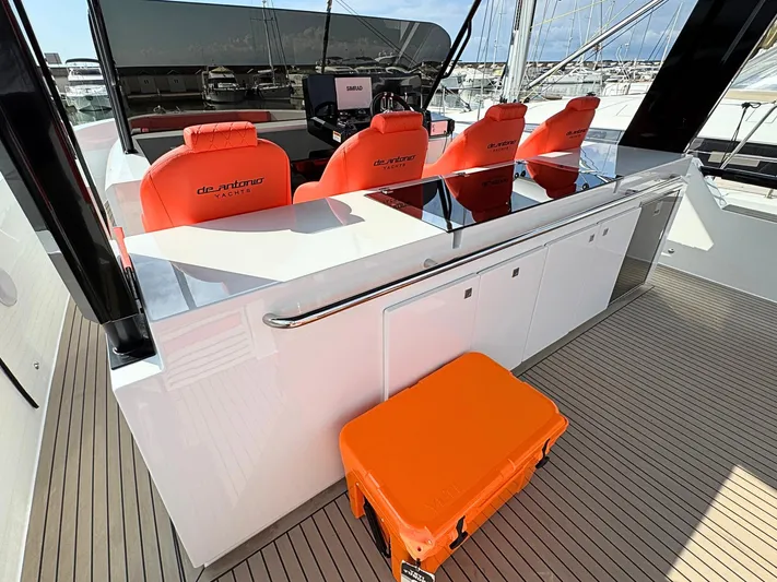  Yacht Photos Pics 2025 De Antonio Yachts D50 cockpit with red seats and sleek design.