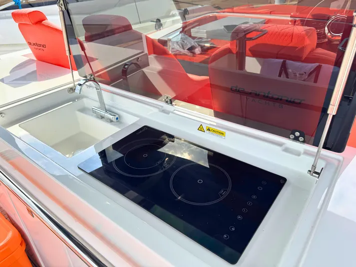  Yacht Photos Pics Modern kitchen area on 2025 De Antonio Yachts D50 with sink and induction cooktop.