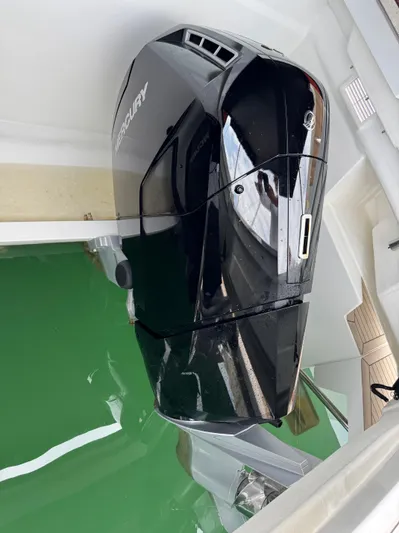  Yacht Photos Pics Mercury outboard motor on 2025 De Antonio Yachts D50, docked in green water.