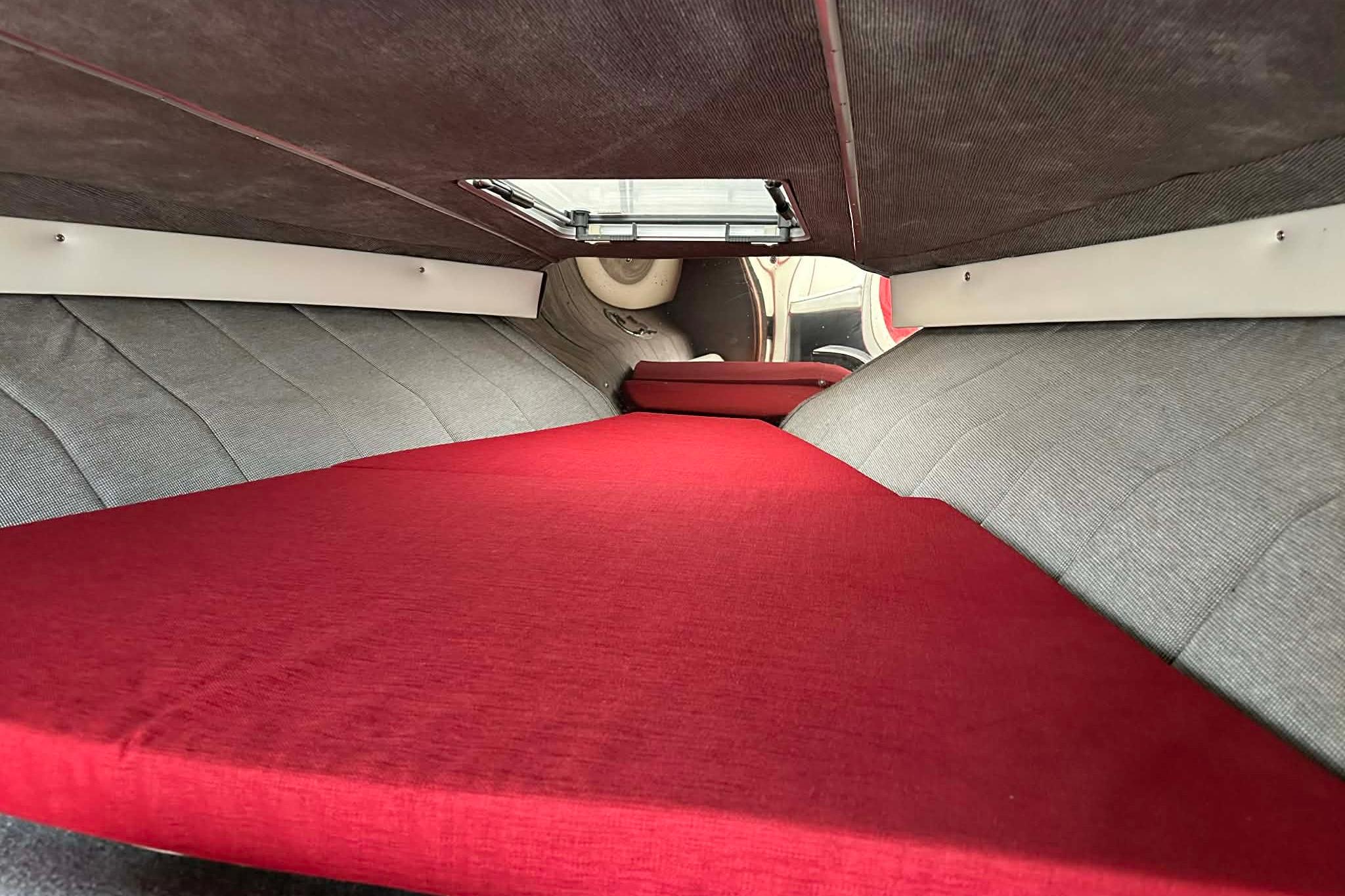 Interior cabin of 1987 IMP 255 Eleganza with red and gray upholstery.