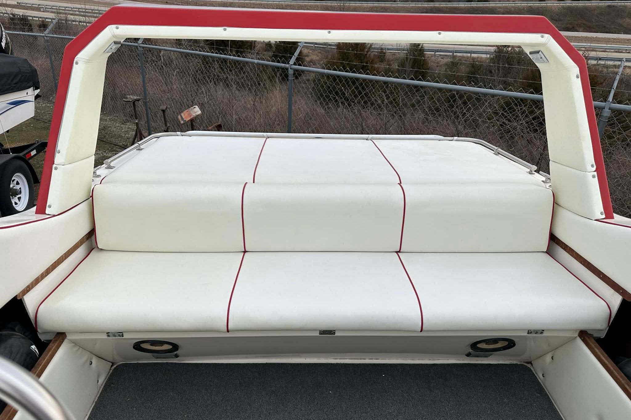 1987 IMP 255 Eleganza boat interior with white and red cushioned seating.