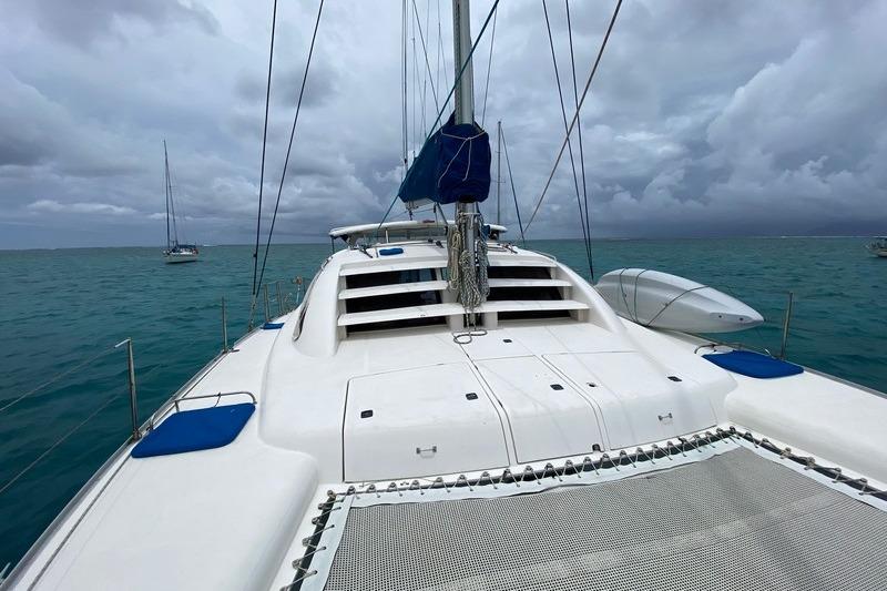 2006 Leopard 40 catamaran on turquoise water under cloudy skies.