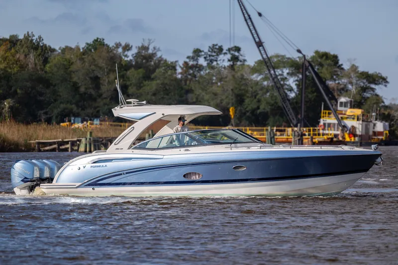  Yacht Photos Pics 2018 Formula 350 Crossover Bowrider OB cruising on a river with scenic background.