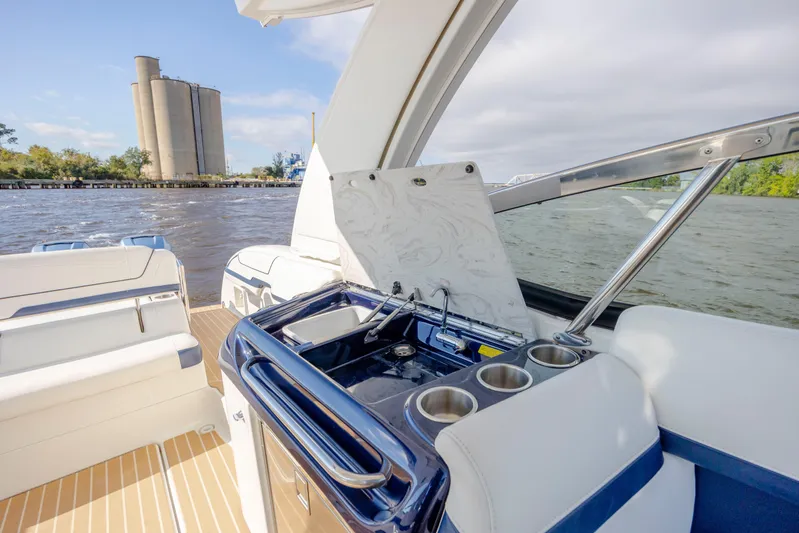  Yacht Photos Pics 2018 Formula 350 Crossover Bowrider OB interior with sink, cup holders, and scenic water view.