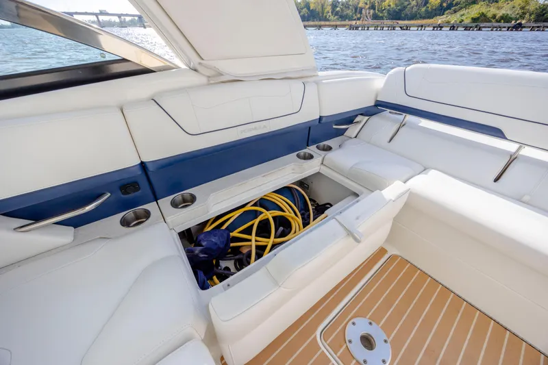  Yacht Photos Pics 2018 Formula 350 Crossover Bowrider OB interior with open storage compartment, white and blue seating.
