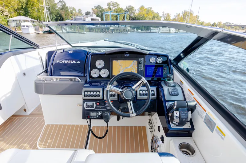  Yacht Photos Pics 2018 Formula 350 Crossover Bowrider OB helm with advanced navigation system on a scenic waterway.