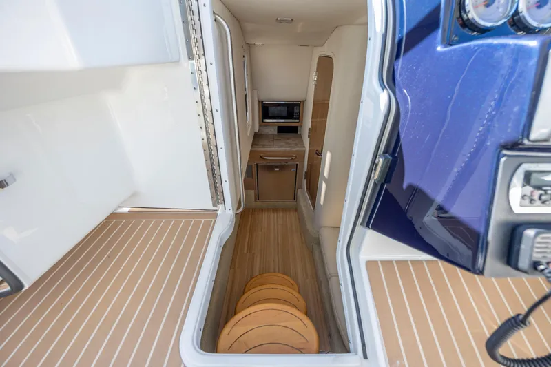  Yacht Photos Pics 2018 Formula 350 Crossover Bowrider OB interior with kitchenette and seating area.