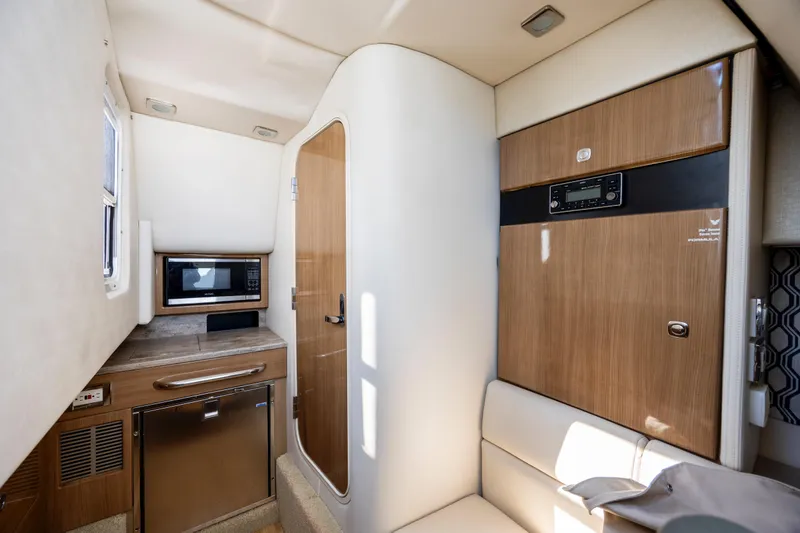  Yacht Photos Pics Interior of 2018 Formula 350 Crossover Bowrider OB with kitchenette and seating area.