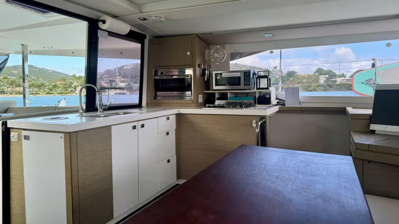  Yacht Photos Pics Interior of 2019 Fountaine Pajot Lucia 40 catamaran with modern kitchen and scenic view.